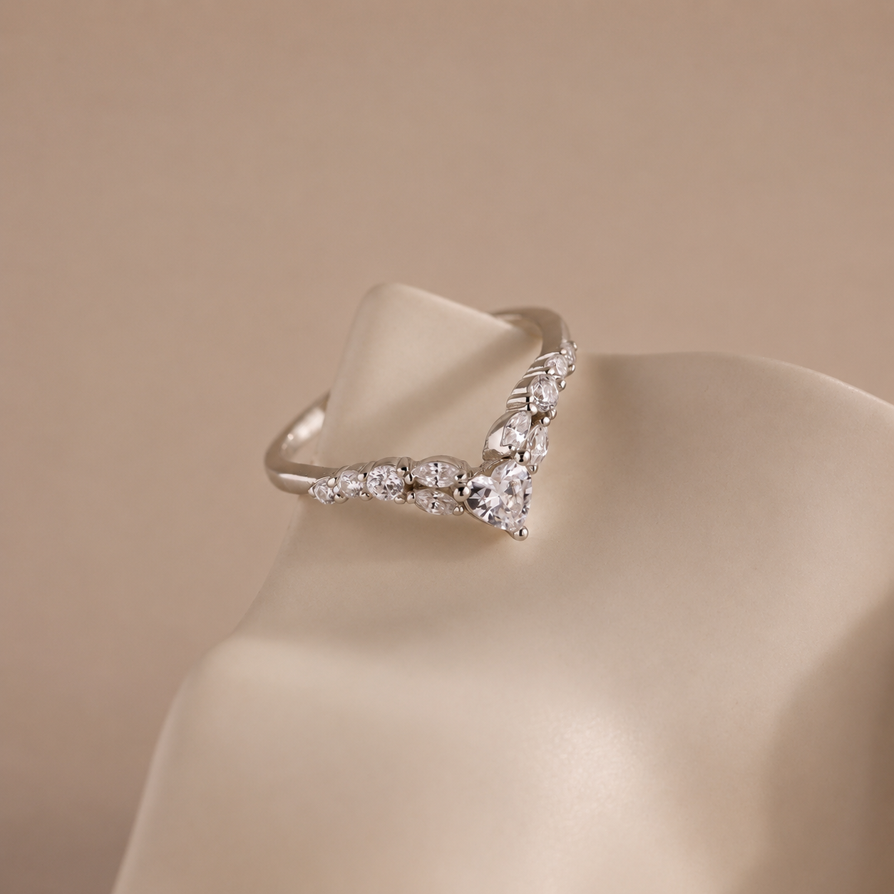 Silver ring with diamonds on a beige mannequin bust